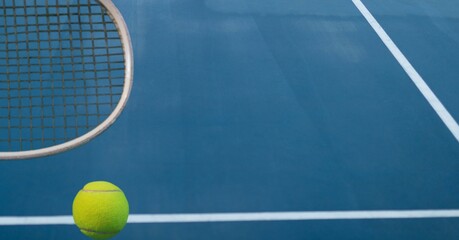 Composition of tennis ball and racket with copy space on tennis court