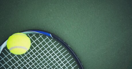 Composition of tennis ball and racket with copy space on tennis court