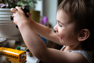 Happy Child Plays with Toys at Home