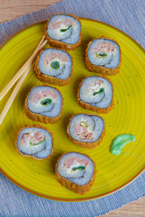 Japanese food, sushi rolls with rice and fish, soy sauce and chopsticks