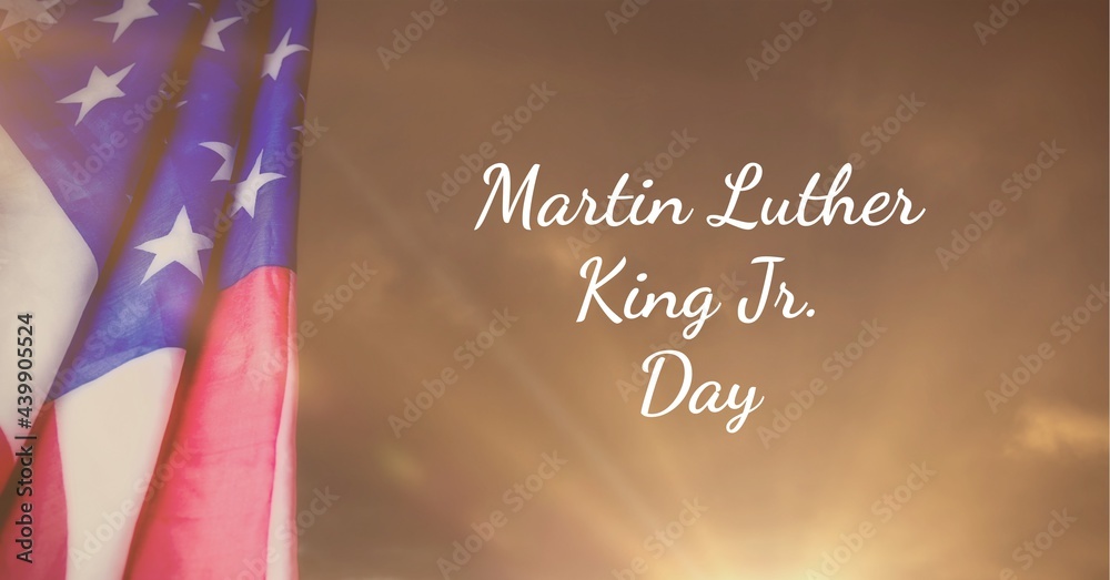 Wall mural happy martin luther king day jr text and american flag against spot of light in background