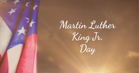 Happy martin luther king day jr text and american flag against spot of light in background