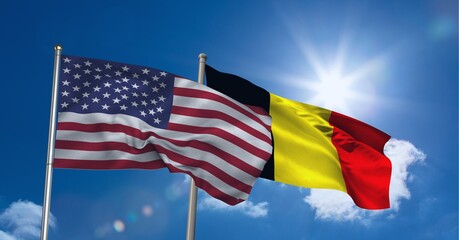 American and german flag waving against clouds in blue sky