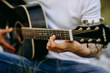 Fototapeta na wymiar man playing guitar, close up