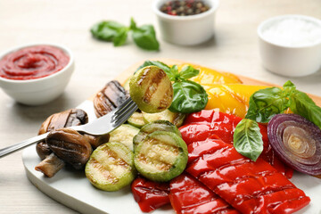 Delicious grilled vegetables on white wooden table, closeup