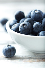 Bilberries on bright wooden background. Close up. 