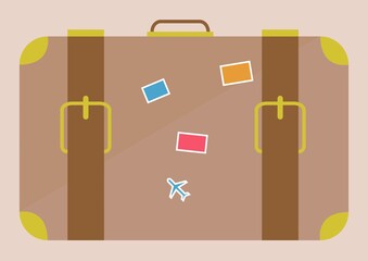 Composition of retro suitcase with stickers on beige background