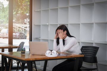 Businesswoman tired, stressed and upset with project work problem.