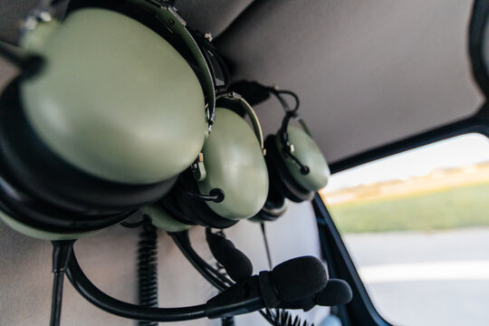 Headphones hanging from the ceiling of a helicopter