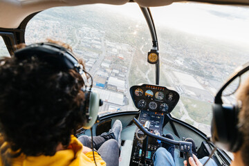 Passenger and pilot of a helicopter flying over the city