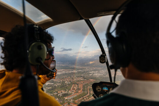 View of rainbow from inside a helicopter through the window
