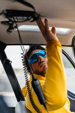 Helicopter pilot with sunglasses preparing to fly