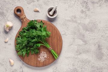 cutting board, parsley on a concrete table