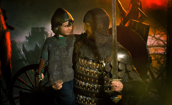 Man And Boy Child In Medieval Historical Costumes.