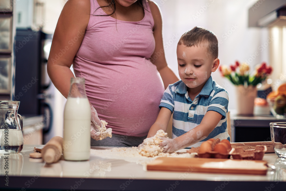 Wall mural Family cooking together in modern home kitchen