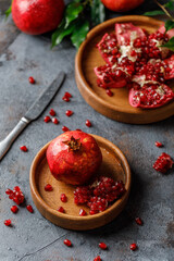 Ripe juicy pomegranate on grey background. Food background