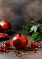 Ripe juicy pomegranate on grey background. Food background