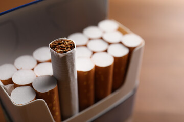 Pack of cigarettes on blurred background, closeup