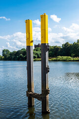 Pillars emerging from the water in the harbor