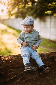 Cute and handsome baby boy 1-2 years old exploring nature in summer, having fun