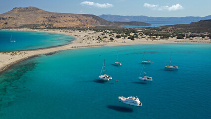 Obraz premium Aerial photo taken by drone of Caribbean tropical exotic island bay with turquoise clear sea sandy beaches resembling a blue lagoon visited by sail boats