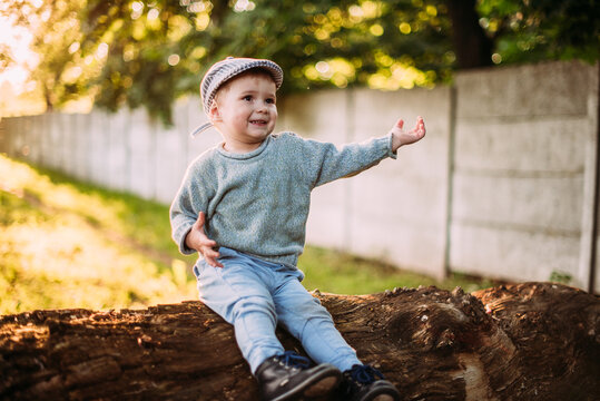 Cute and handsome baby boy 1-2 years old exploring nature in summer, having fun