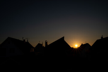 Sunrise over the roofs of the village