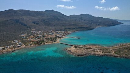 Naklejka premium Aerial drone photo of main port of Kythera island and turquoise exotic beach of Diakofti, Ionian, Greece
