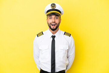 Airplane arab pilot man isolated on yellow background with surprise facial expression