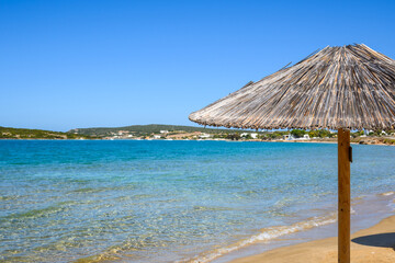 Straw umbrella at Xifara beach, a small and quiet beach located in Naoussa Bay on Paros island, Cyclades, Greece