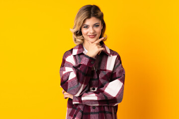 Young Russian woman isolated on yellow background thinking an idea while looking up