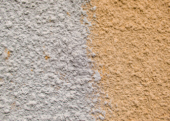 Texture of yellow and gold colors. The wall is split in half. Copy space. 