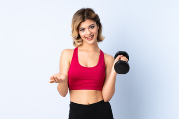 Teenager Russian girl making weightlifting isolated on blue background making doubts gesture while lifting the shoulders