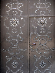 Old door with symbols and decorations in old part of town in Warsaw.