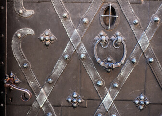 Old door with symbols and decorations in old part of town in Warsaw.