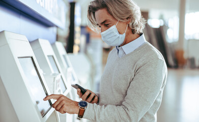 Man using self service check in at the airport