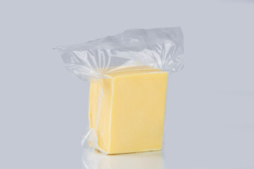 Cubo de queso mozzarella empacado al vacío en un fondo blanco de estudio 