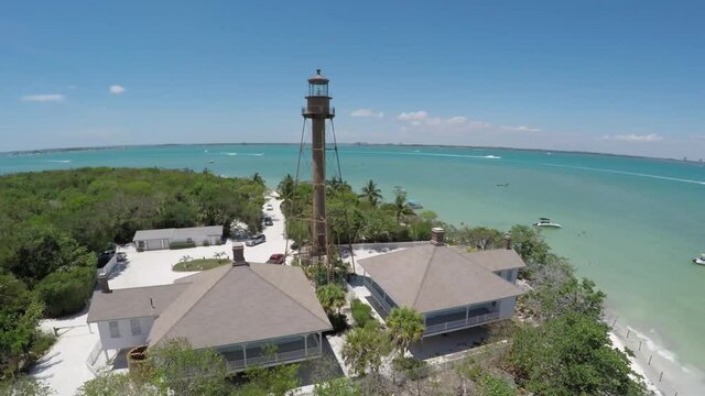 Sanibel Island Light House Aerial Fly In Then Over To Water Beach