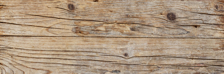 Old brown wood background made of dark natural wood in grunge style. The view from the top. Natural raw planed weathered texture. The surface of the table to shoot flat lay. Copy space.Banner