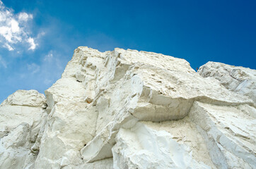 Ancient multimillion chalk mountains against the blue sky. Natural Chalk mining