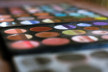 Rows of cosmetics in a messy palette.