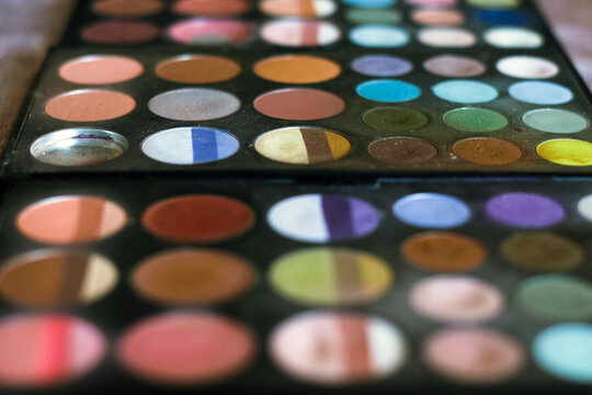 Rows of cosmetics in a messy palette.