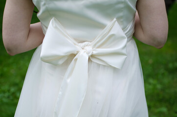 back view of wedding dress with white bow