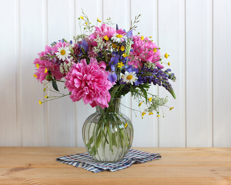 Garden And Wild Flowers And Herbs In A Glass Vase.