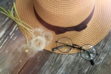 Summer 2021 calendar, summer straw hat and fluffy dandelions.