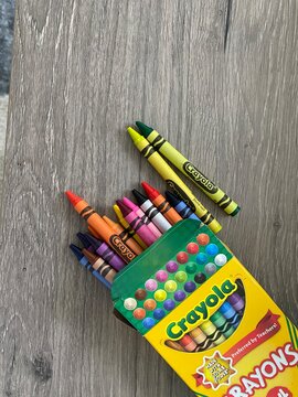 new crayola crayons on a gray wooden background table 