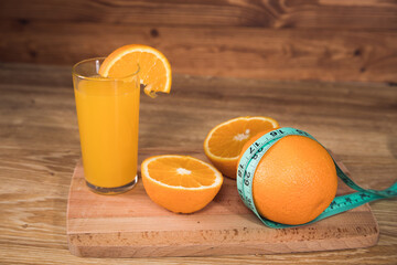 orange on the table, measuring tape and orange juice © Fantastic