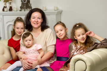 Studio Portrait of Happy Family of Mother and Three Daughters