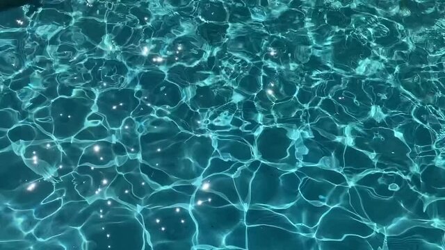 Blue water background. Blue shiny water background. Freshness, summer, relax.