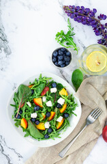 Fresh salad with nectarines, blueberries, arugula, spinach and feta cheese